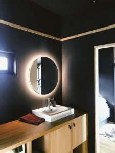 a modern bathroom interior having a mirror with backlight