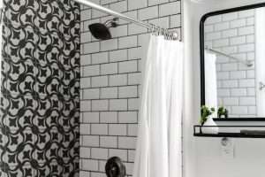 a bathroom interior with black and white tiles