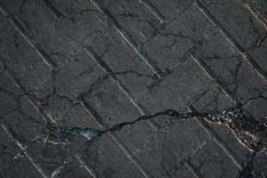 cracked paving stones in front of house